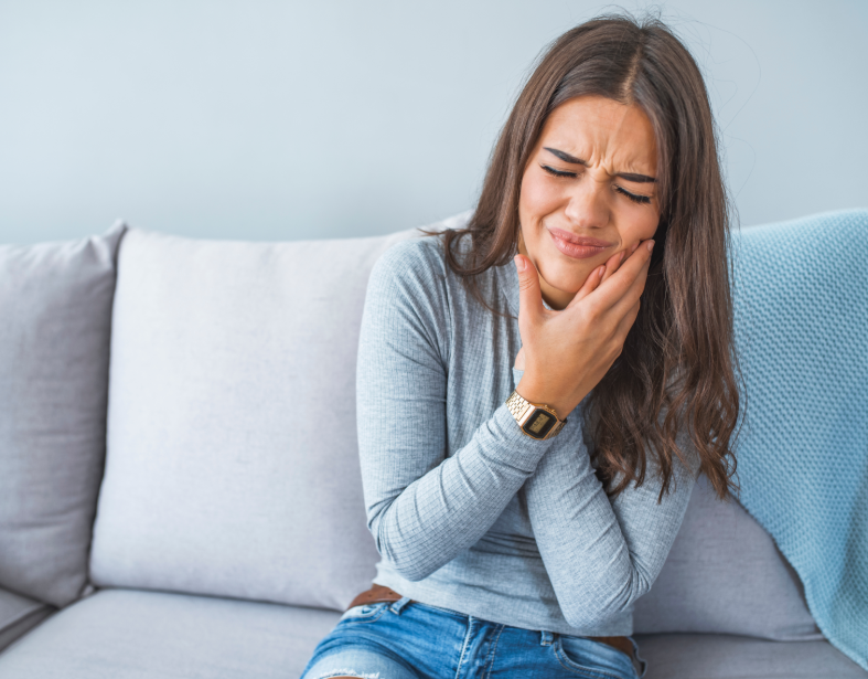 Woman holding jaw in pain